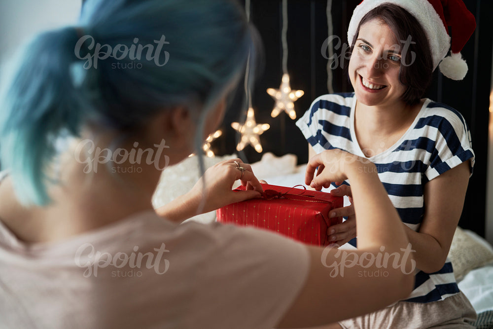 Happy lesbian couple giving Christmas presents