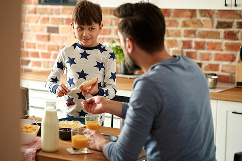 Father and son preparing breakfast together