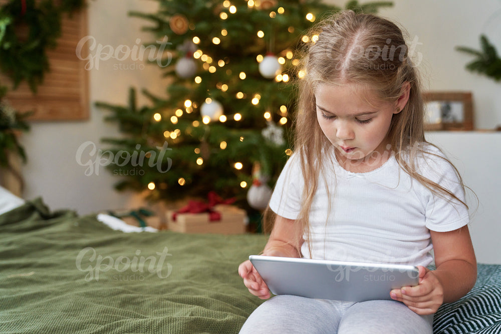 Little girl spending Christmas with wireless technology