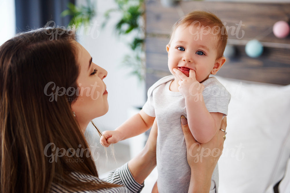 Young woman playing with her little baby girl