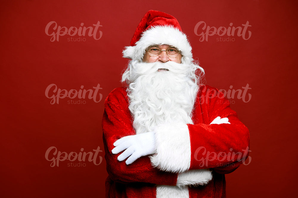 Portrait of smiling caucasian Santa Claus on red background 