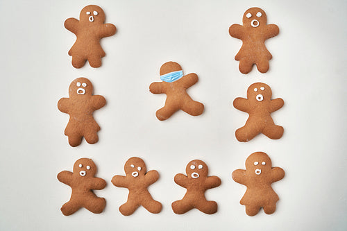 Top view of gingerbread man and one with protective masks