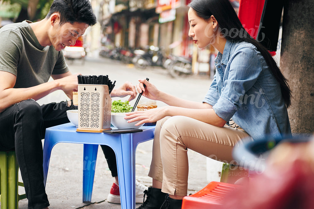 Tourists eating street food in Vietnam