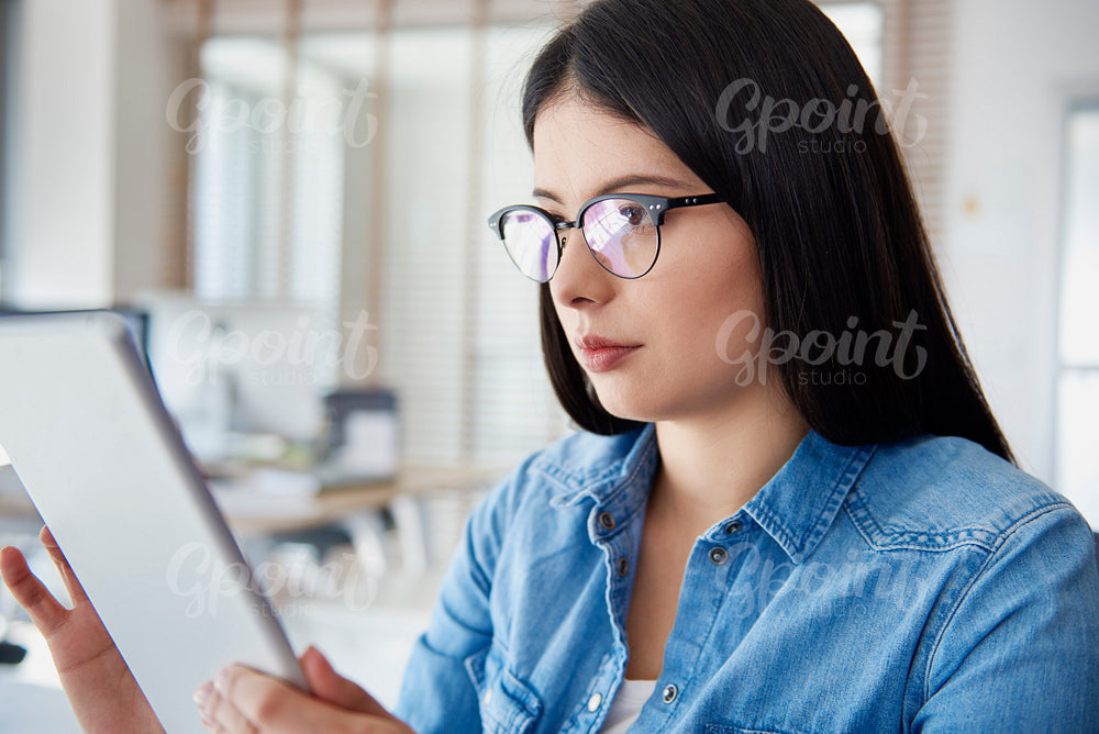 Asian woman using digital tablet in the office