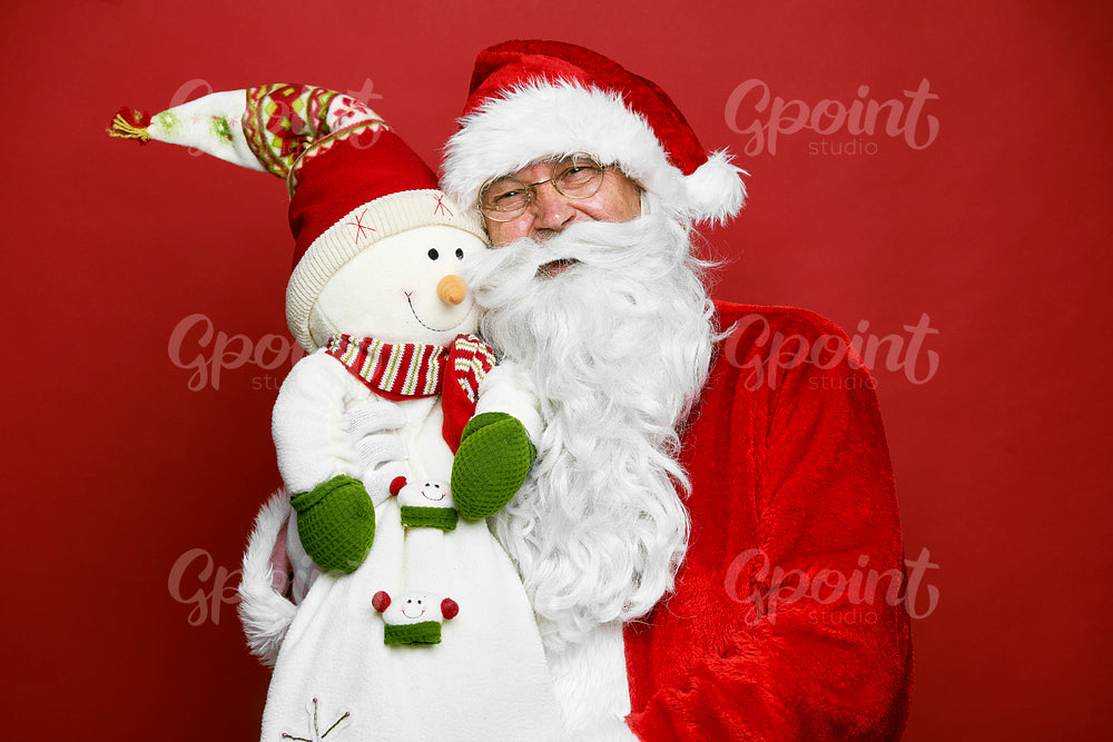 Portrait of caucasian Santa Claus with cute snowman 