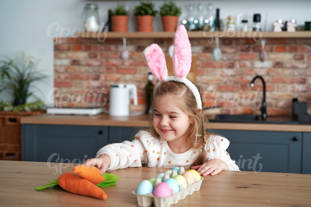 Smiling girl taking a handmade carrot from the table