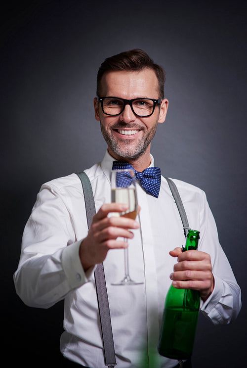 Elegant man with bottle of champagne and champagne flute