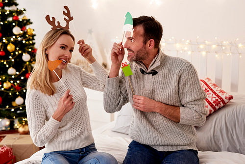 Playful couple in Christmas masks