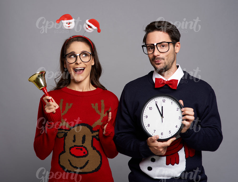 Playful couple announcing the Christmas time