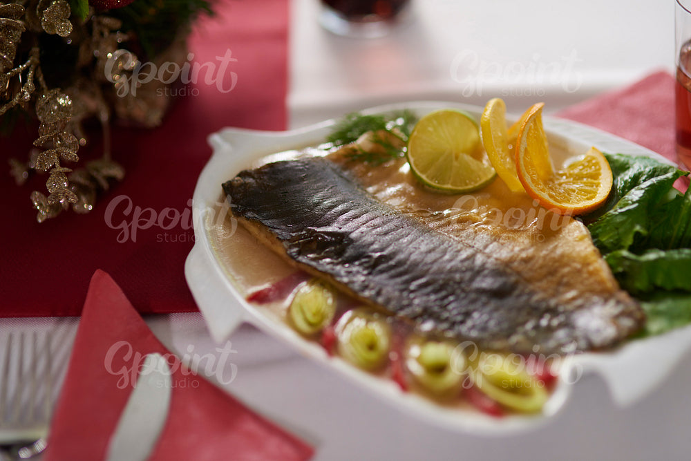 Delicious carp decorated with vegetables and citrus