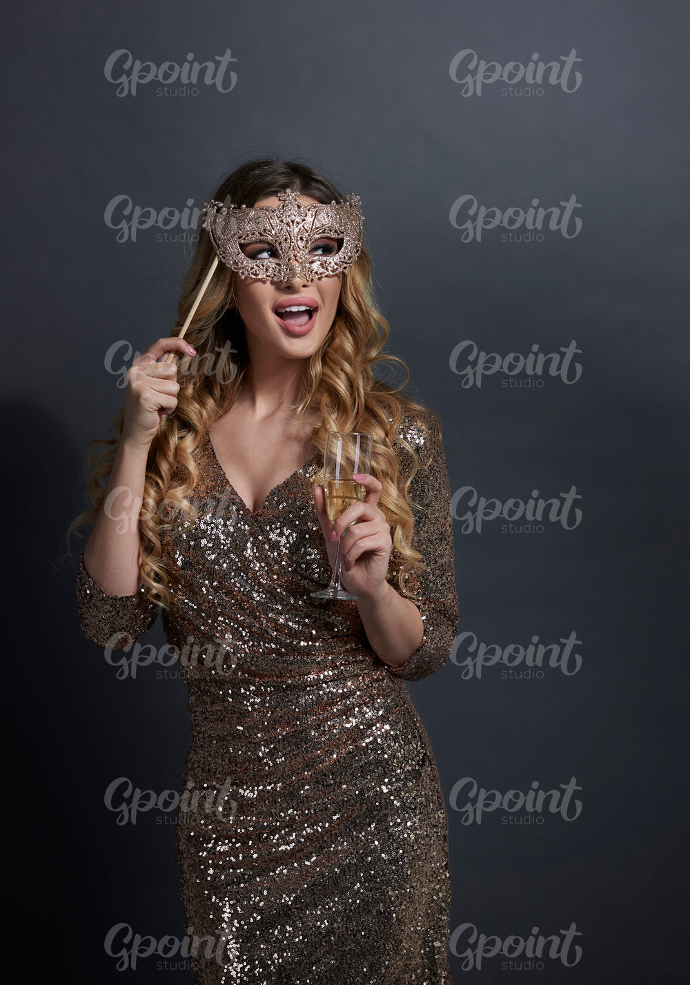 Shouting woman with mask drinking champagne