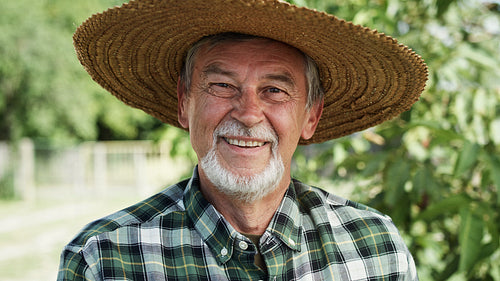 Close up video portrait of happy farmer in a hat