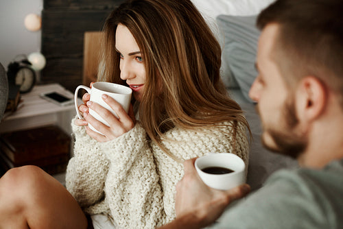 Couple with coffee at bedroom