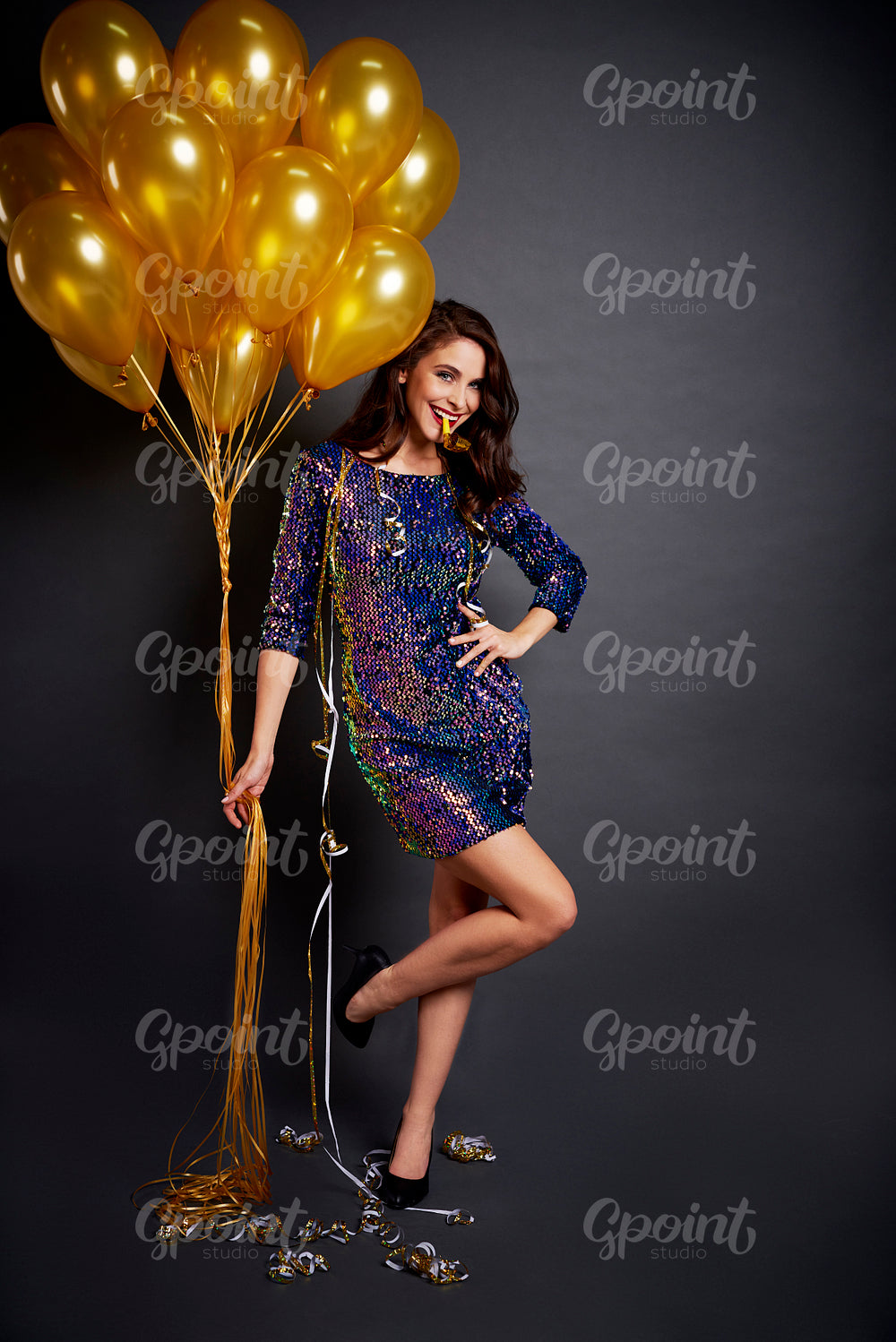 Portrait of glamorous woman with golden balloons