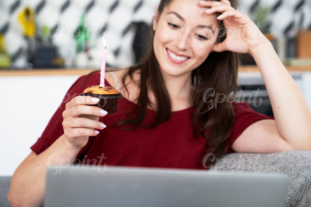 Front view of woman celebrating birthday alone at home