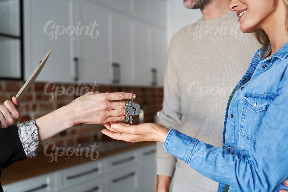 Woman gives the keys to the clients