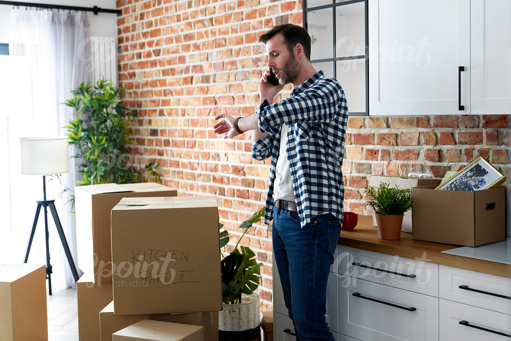 Displeased man calling for help with moving house