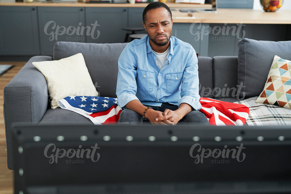 Disappointed man in front of TV
