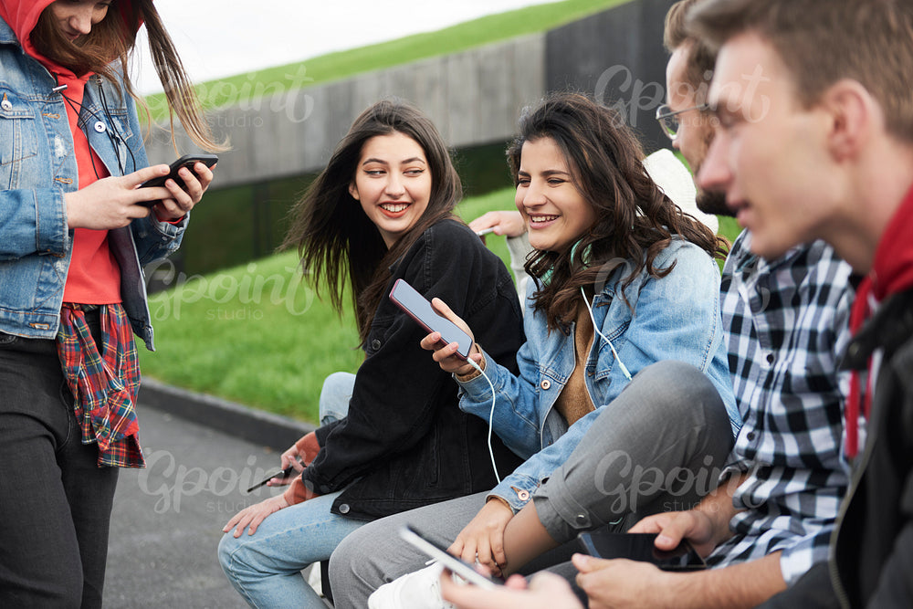 Young people with mobile phone in the city