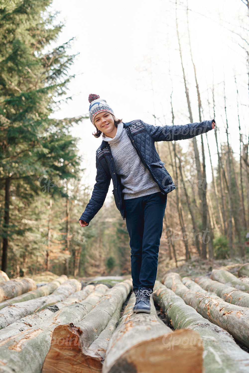 Happy teenage boy having a fun in the autumn forest