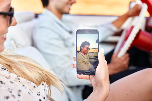 Woman making a selfie of her man during road trip