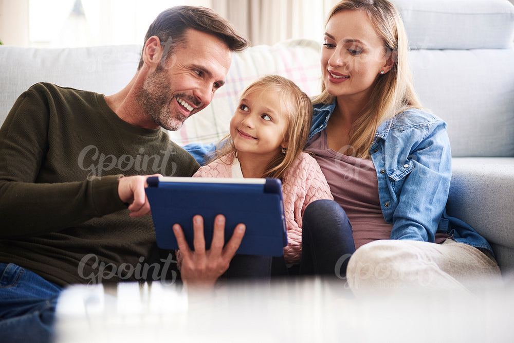 Parents and daughter using tablet