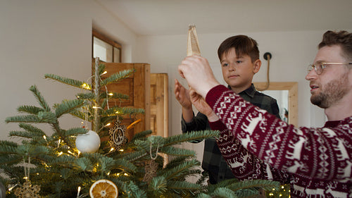 Father and son decorating the Christmas tree