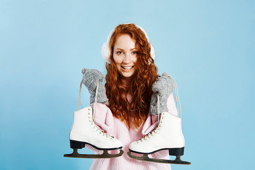 Portrait of smiling girl holding ice skates