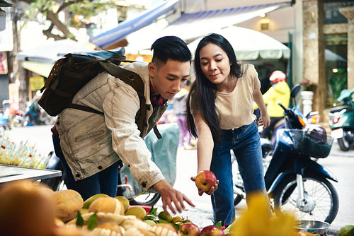 Tourists buying fruit at the street market