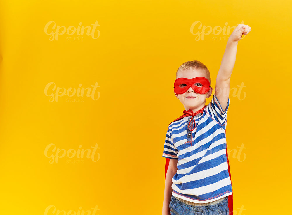 Front view of boy wearing a superhero costume