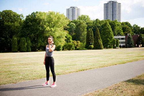 Young woman catching a short break during jogging