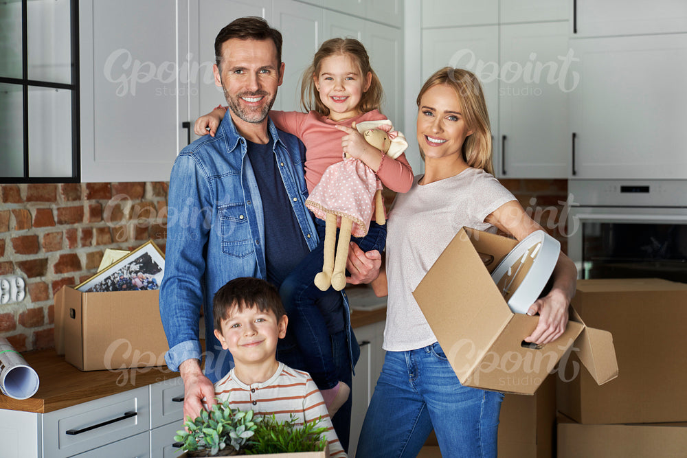 Portrait of happy family with children in a new apartment