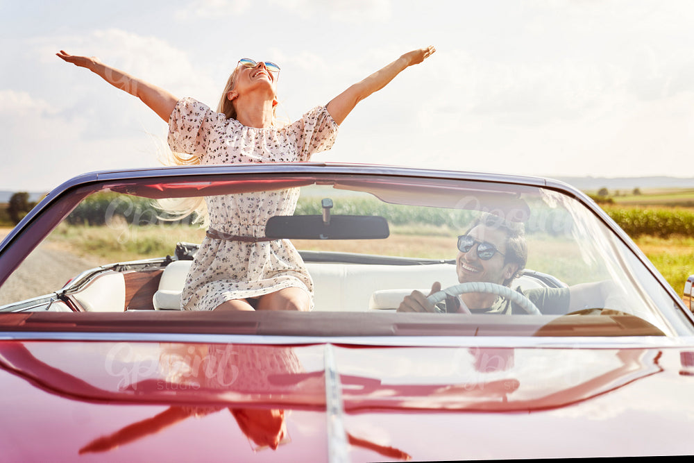 Front view of happy young people in a cabriolet