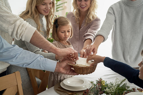 Caucasian family sharing wafer during the Christmas Eve