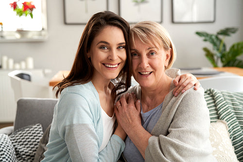 Portrait of mother and adult daughter at home
