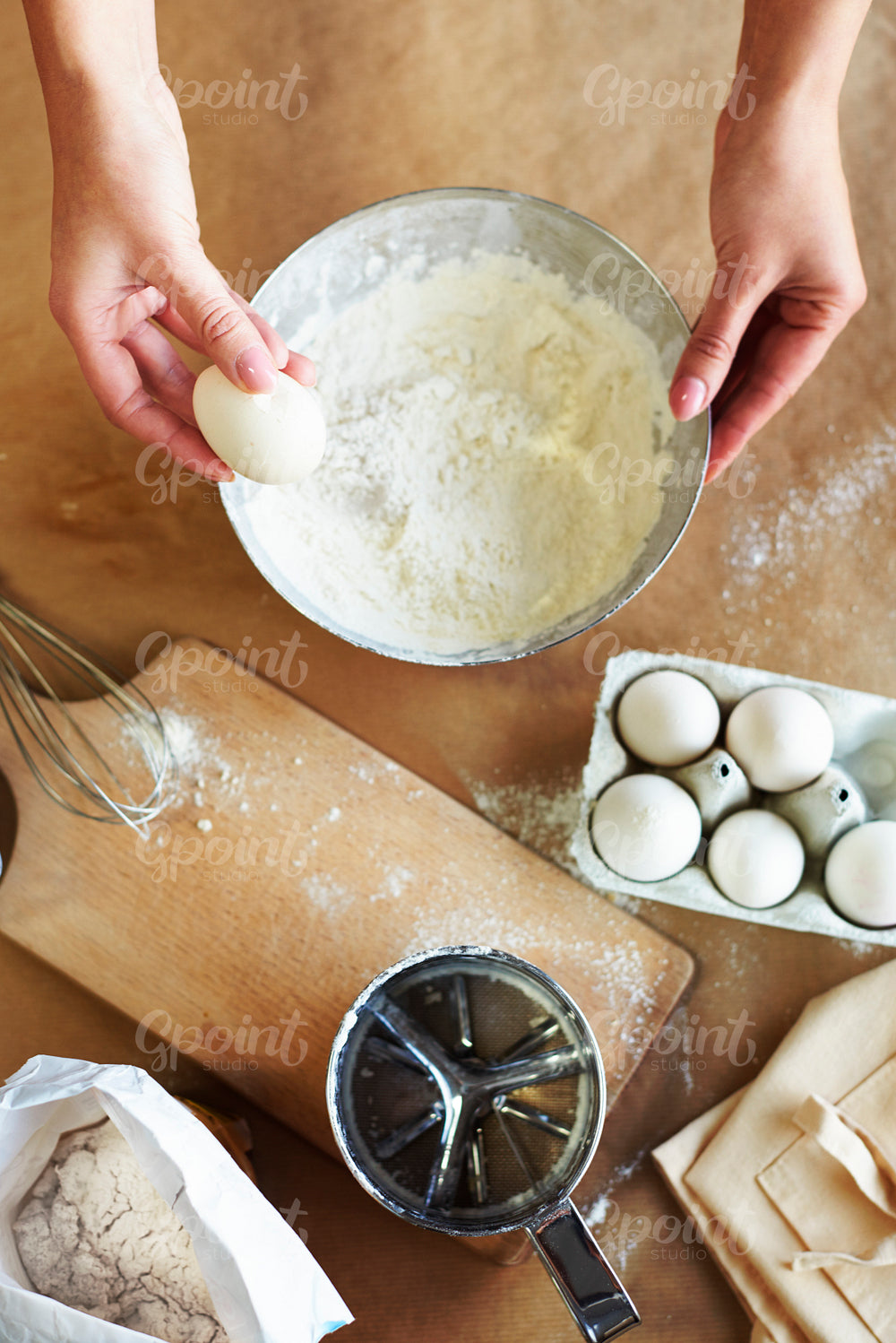 Hands of woman and baking ingredients