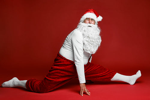 Shocked caucasian Santa Claus does the splits