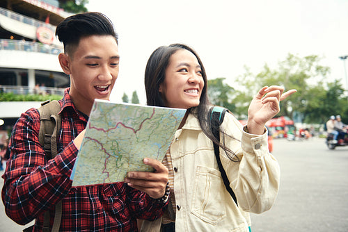 Asian couple using paper map on the street