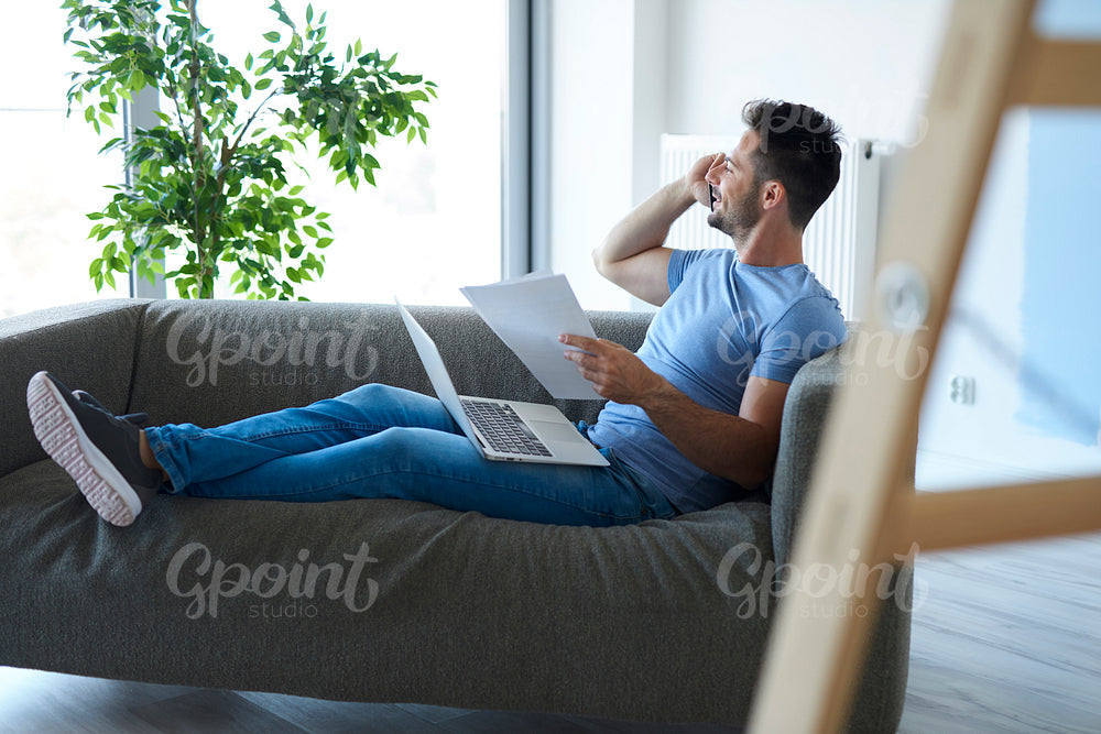 Young man working with technology in living room