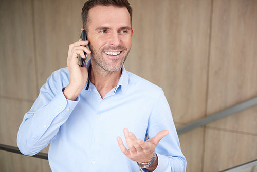 Businessman talking on the phone at work