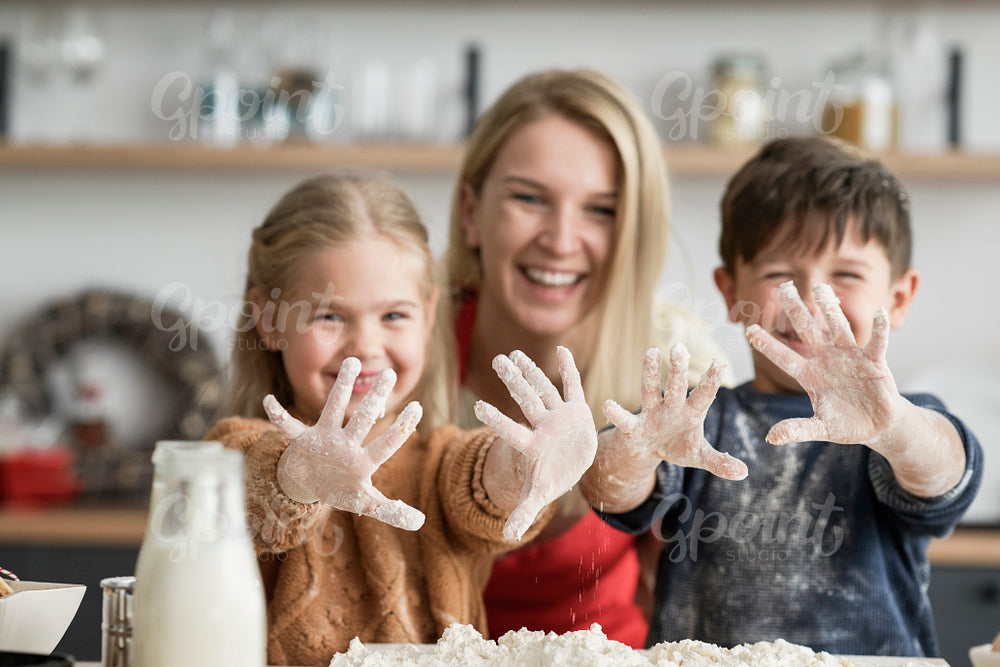 Children showing dirty hands after baking