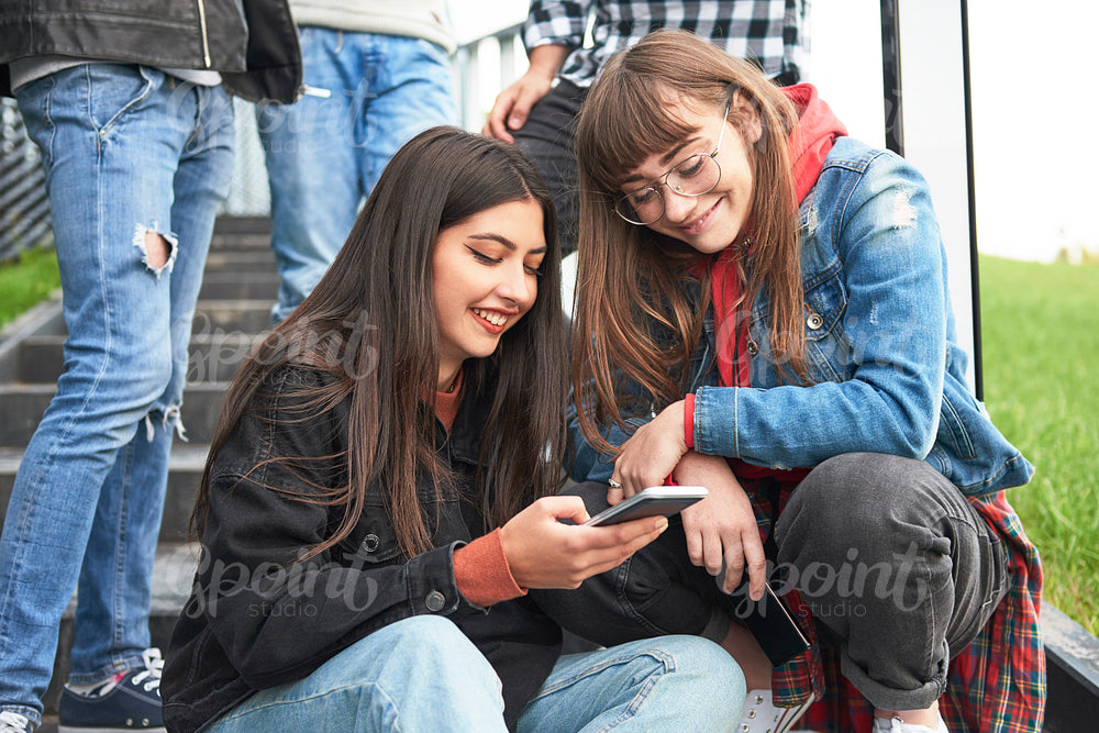 Two young women looking at mobile phone
