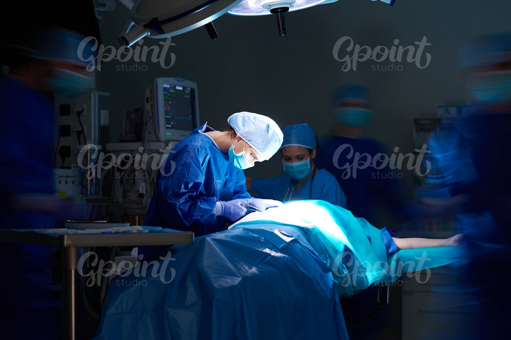 Dark operating room and hospital staff