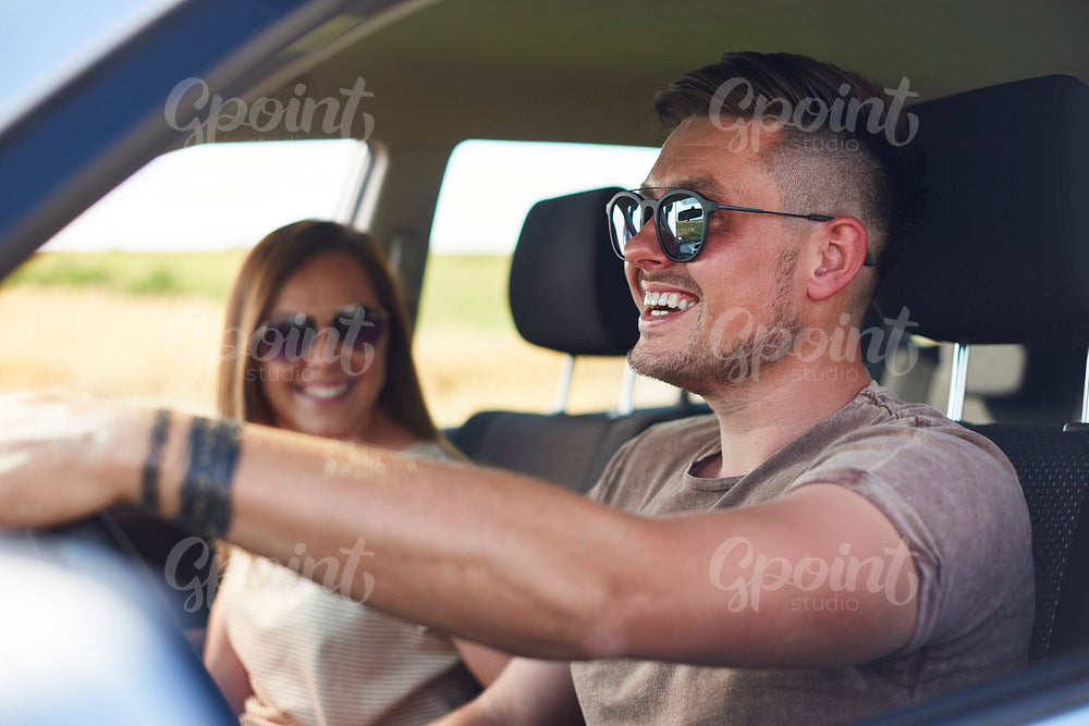 Young couple traveling by car in summertime