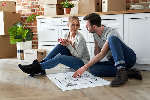 Couple sitting on the floor in their new apartment
