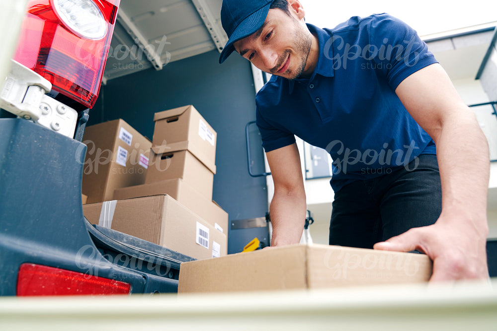 Courier unloading packages on the hand truck