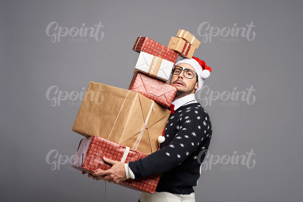 Man carrying  a lot of Christmas presents