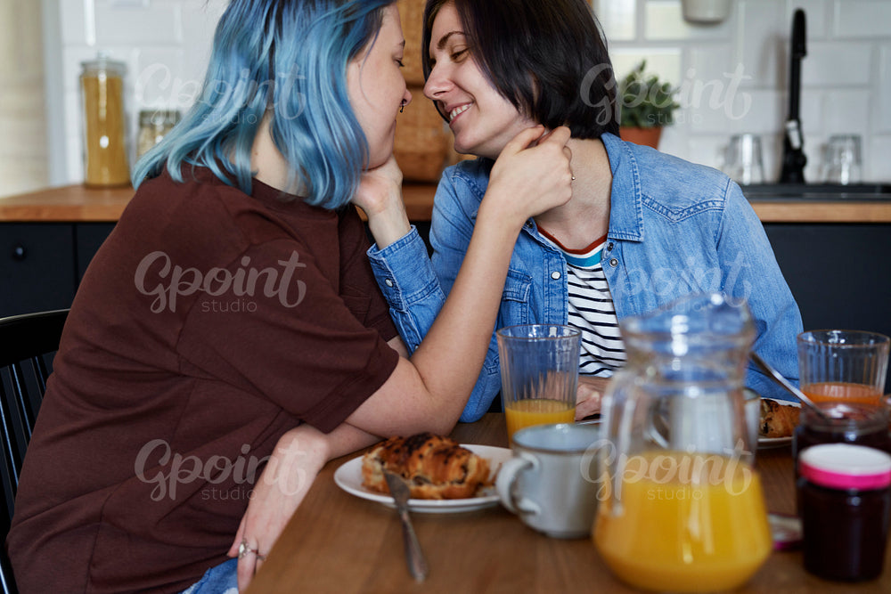 Happy lesbian couple having breakfast