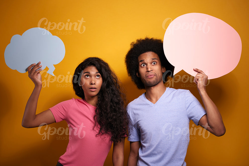 Shocked Afroamerican couple with speech bubbles