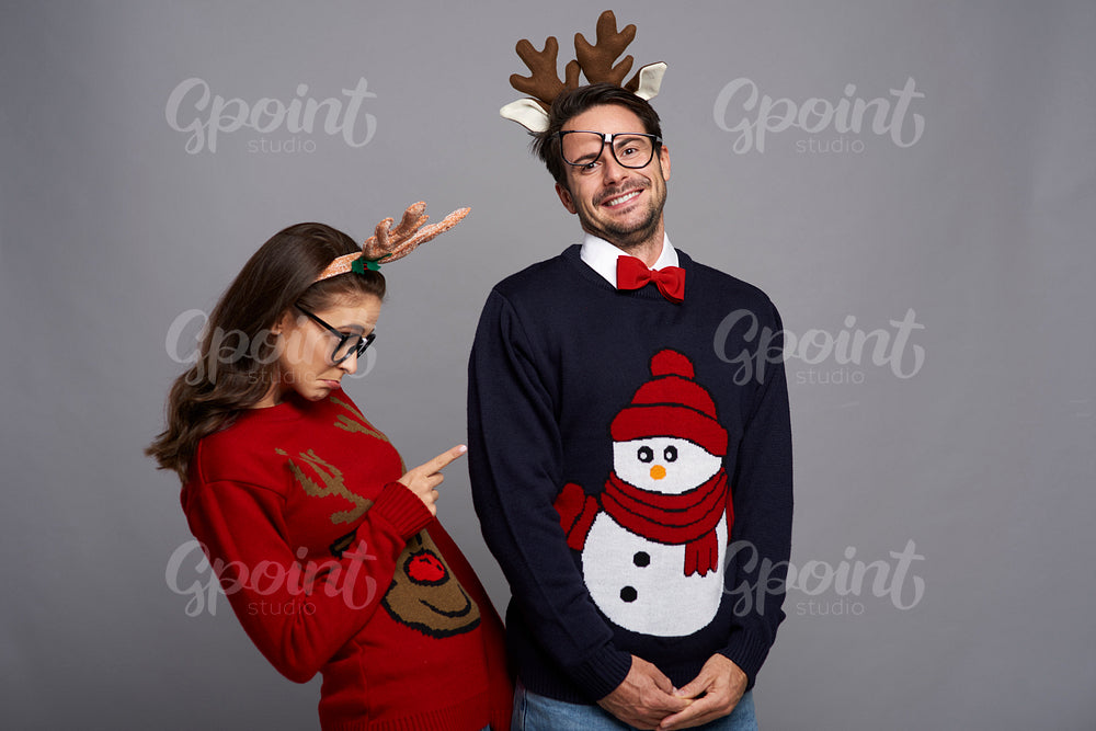 Funny couple posing in Christmas clothes